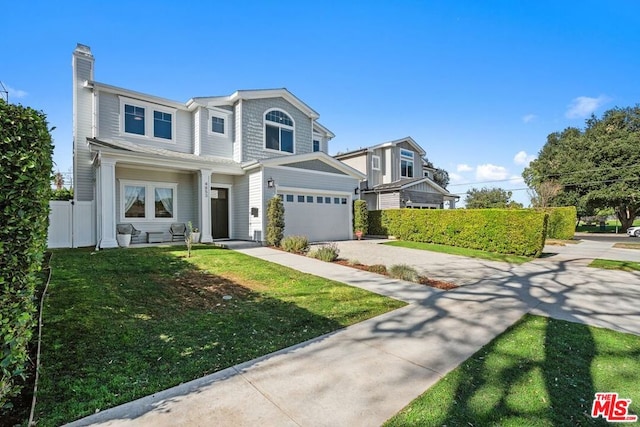 view of front of property featuring a garage and a front yard