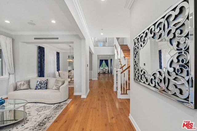 living room featuring ornamental molding and wood-type flooring