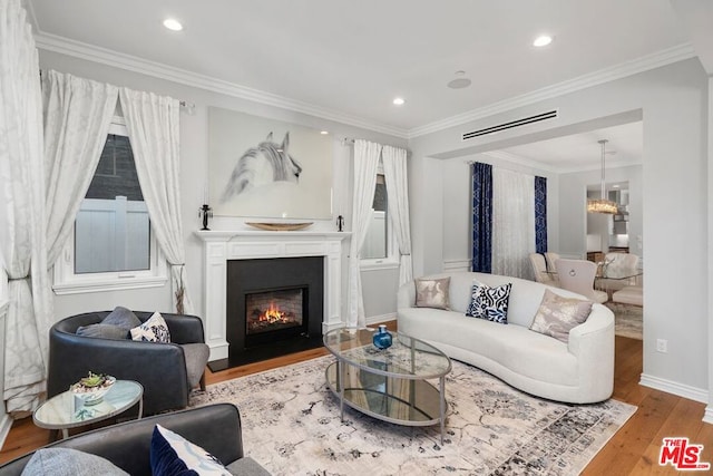 living room featuring ornamental molding and light wood-type flooring