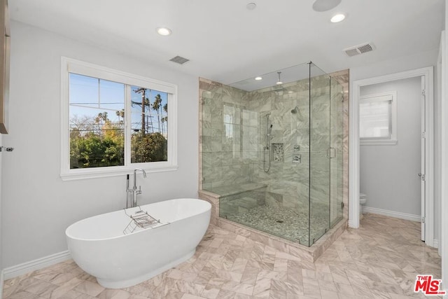 bathroom with shower with separate bathtub