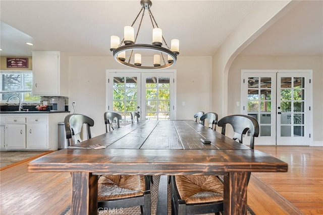 dining room featuring a wealth of natural light, an inviting chandelier, and french doors