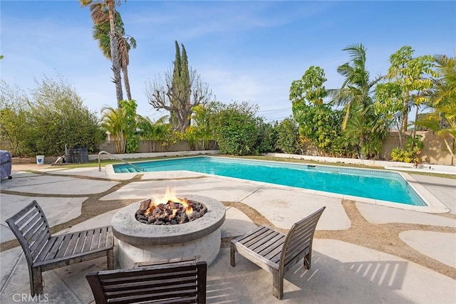 view of pool with a patio area and a fire pit