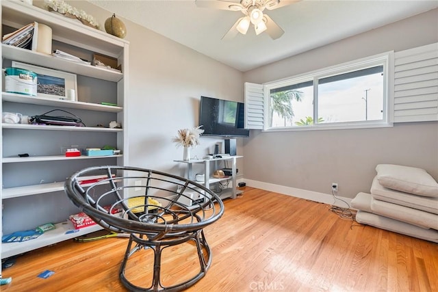 sitting room with light hardwood / wood-style flooring and ceiling fan