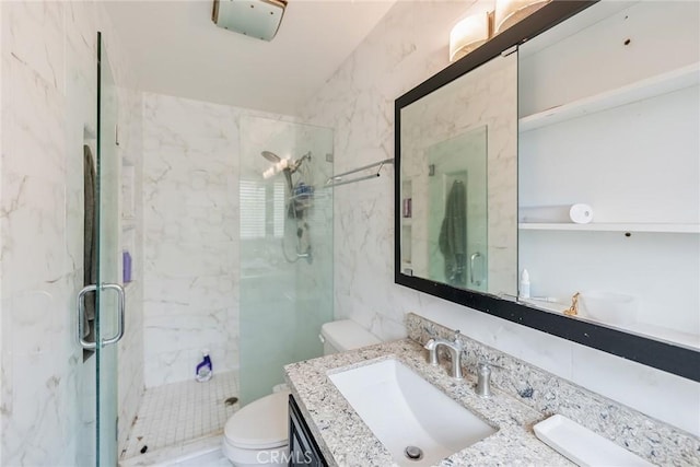 bathroom featuring vanity, tile walls, walk in shower, and toilet