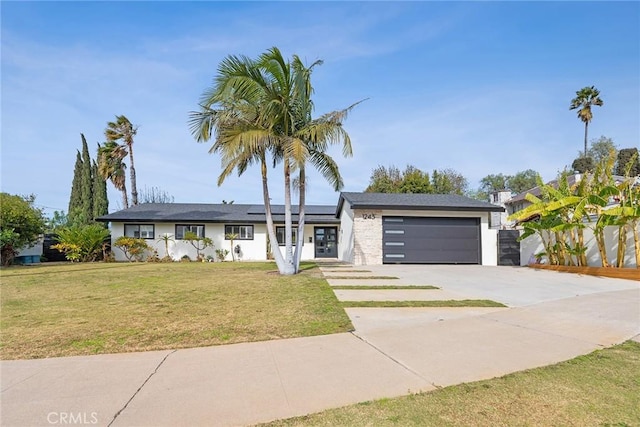 view of front of home featuring a garage and a front lawn