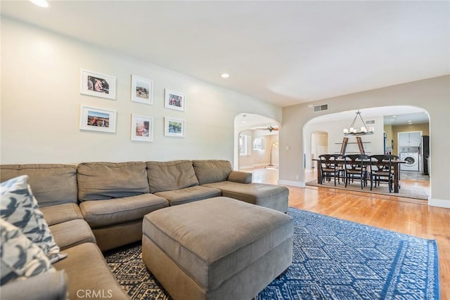 living room with an inviting chandelier and hardwood / wood-style floors