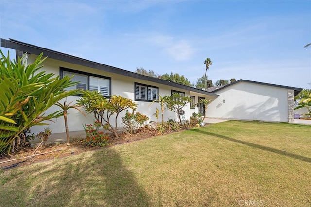 ranch-style house with a front lawn