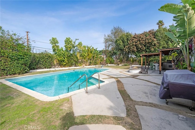 view of swimming pool featuring area for grilling, a patio area, a hot tub, and an outdoor fire pit