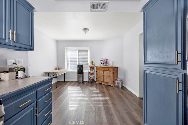 kitchen with blue cabinets and dark hardwood / wood-style floors