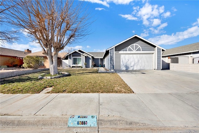 ranch-style house featuring a garage and a front yard