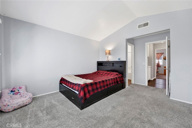 bedroom with lofted ceiling and carpet flooring