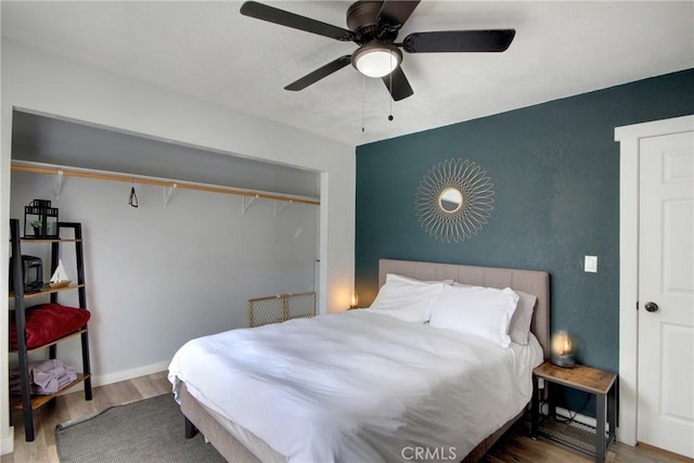 bedroom featuring hardwood / wood-style flooring and ceiling fan