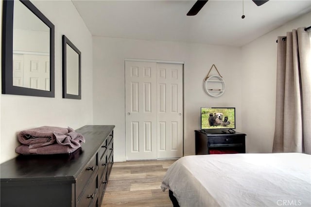 bedroom with ceiling fan, a closet, and light wood-type flooring