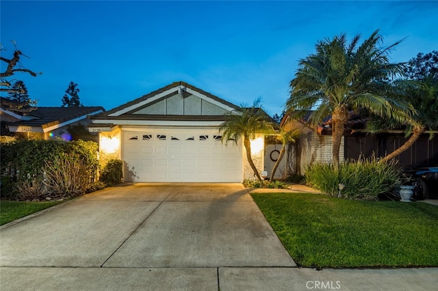 ranch-style home featuring a garage and a front yard