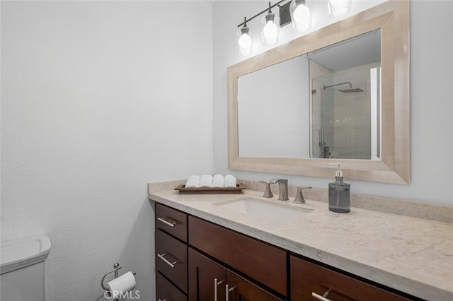 bathroom featuring vanity, an enclosed shower, and toilet