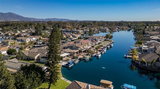 birds eye view of property with a water and mountain view