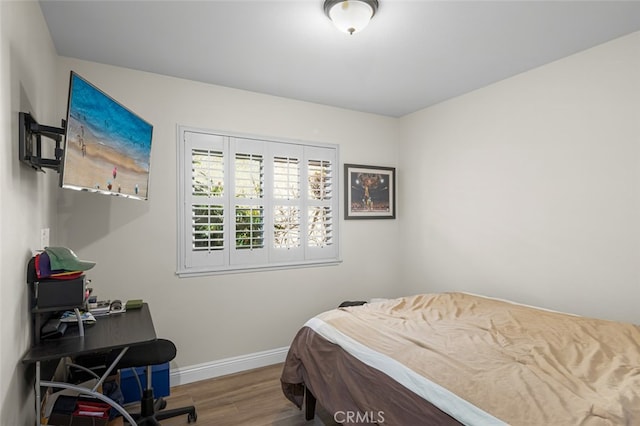 bedroom with hardwood / wood-style flooring