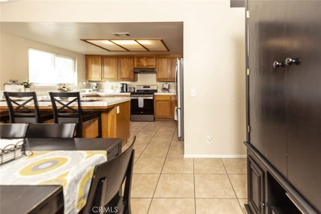 kitchen featuring light tile patterned floors and appliances with stainless steel finishes