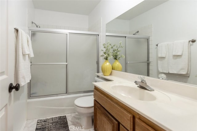 full bathroom with vanity, enclosed tub / shower combo, and toilet