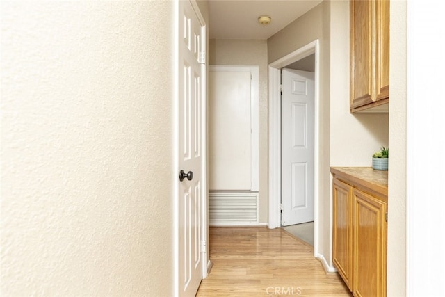 hall with light hardwood / wood-style flooring