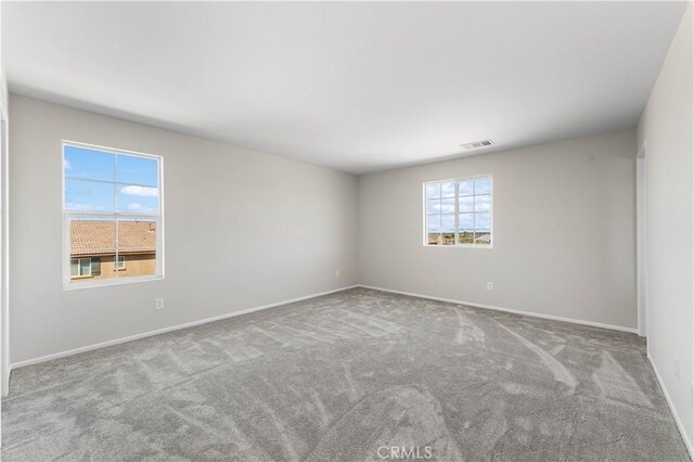 unfurnished room with light colored carpet