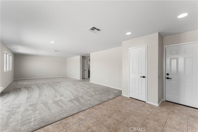 unfurnished room with light colored carpet