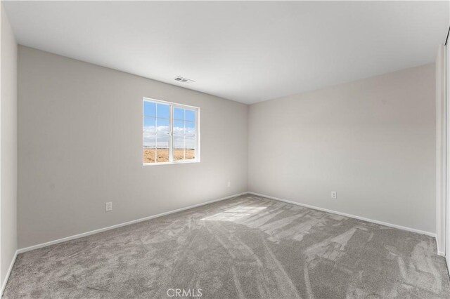 empty room featuring light colored carpet