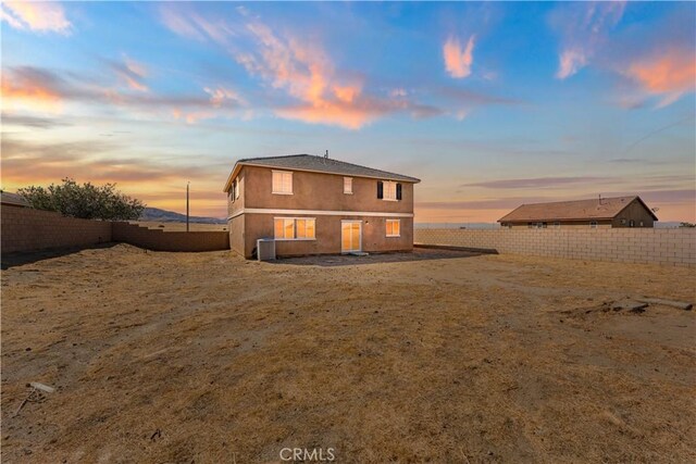 view of back house at dusk