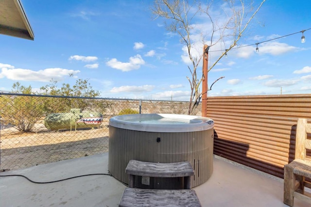 view of patio / terrace with a hot tub