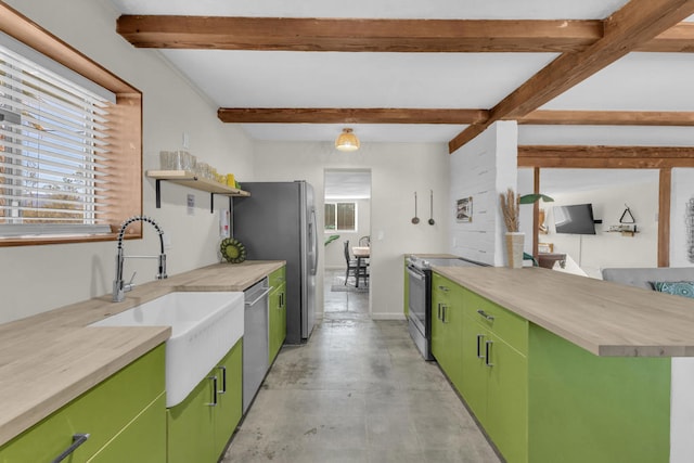 kitchen featuring appliances with stainless steel finishes, sink, green cabinets, and beam ceiling