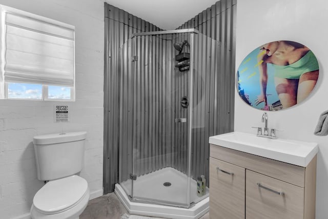 bathroom with vanity, a shower with shower door, and toilet