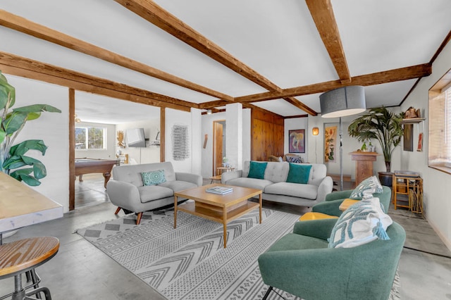 living room featuring beam ceiling and pool table