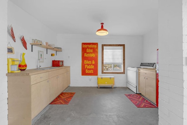 kitchen featuring washer / dryer, sink, and white range with electric stovetop