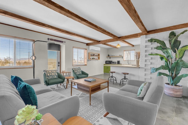 living room featuring beamed ceiling, plenty of natural light, and a wall unit AC