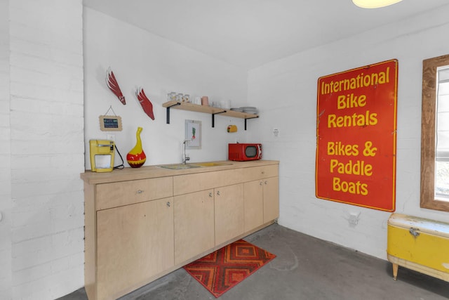 interior space with sink and concrete floors