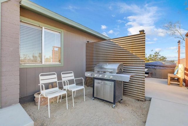 view of patio / terrace with a hot tub and area for grilling