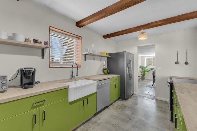 kitchen featuring butcher block countertops, sink, beam ceiling, stainless steel appliances, and green cabinetry