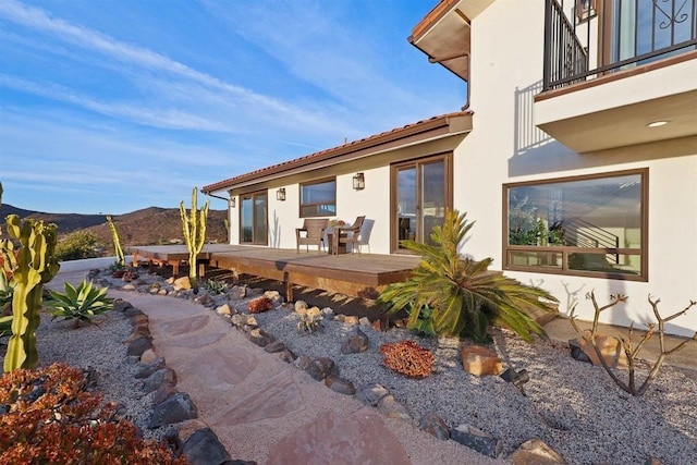 exterior space with a balcony and a mountain view