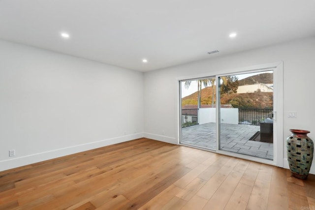 spare room with light hardwood / wood-style flooring