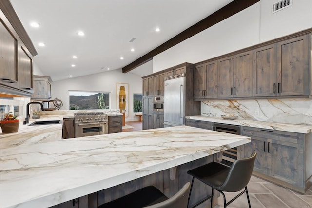 kitchen featuring lofted ceiling with beams, sink, backsplash, high end appliances, and dark brown cabinets