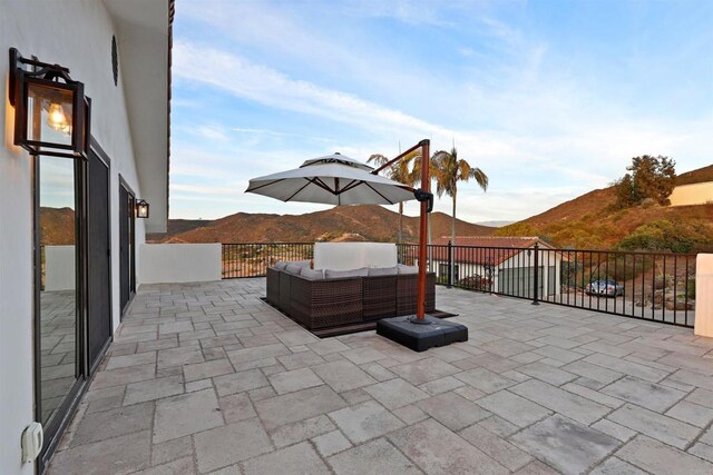 view of patio / terrace featuring an outdoor living space and a mountain view