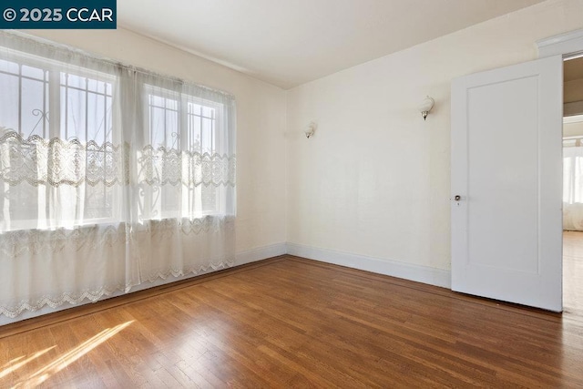 empty room featuring wood-type flooring