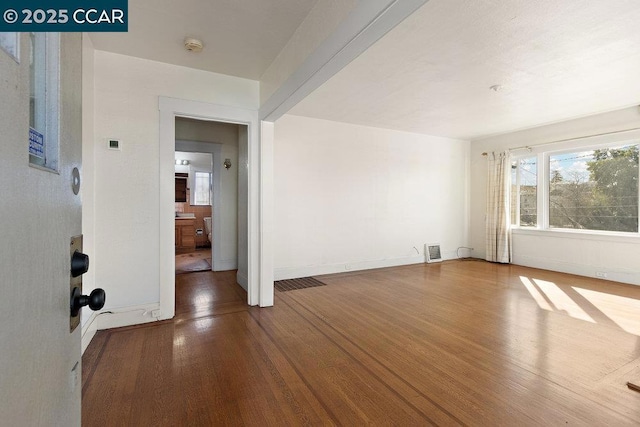 empty room with hardwood / wood-style flooring