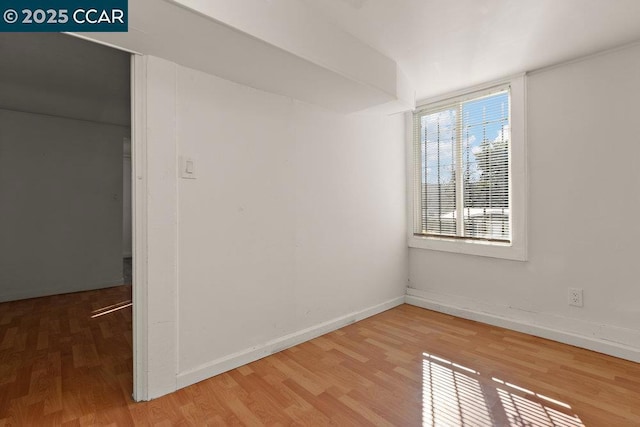 unfurnished room with wood-type flooring