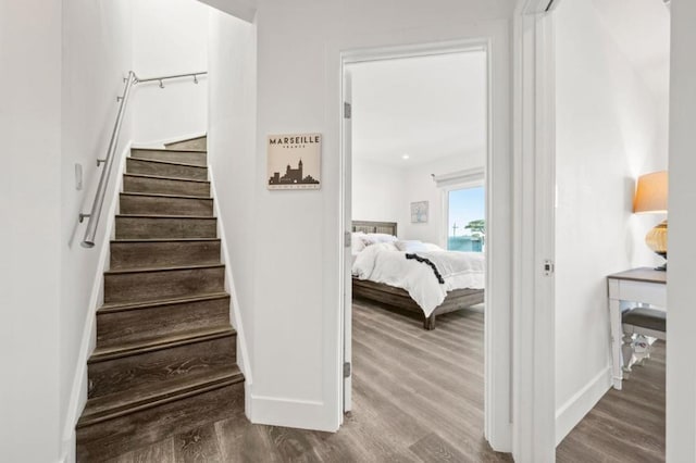 staircase with hardwood / wood-style floors