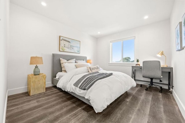 bedroom with dark hardwood / wood-style floors