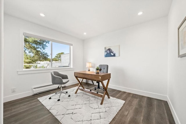 office area featuring a baseboard heating unit and dark hardwood / wood-style flooring