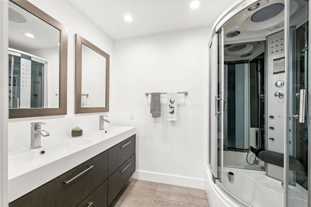 bathroom with vanity and shower / bath combination with glass door