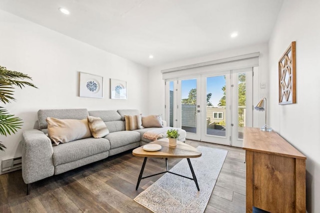 living room featuring a baseboard heating unit, hardwood / wood-style flooring, and french doors