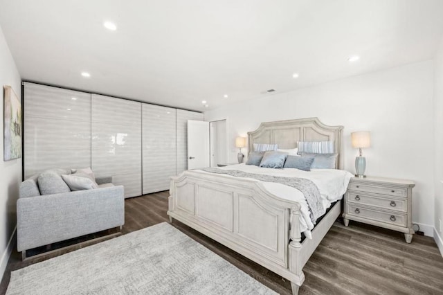 bedroom with dark wood-type flooring